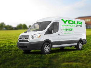 The company's delivery van parked on grass.